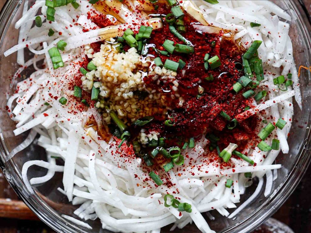 all ingredients in bowl for korean radish salad